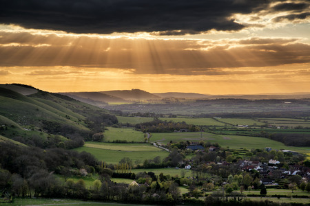 Stunning Summer sunset across countryside escarpment landscapeの写真素材