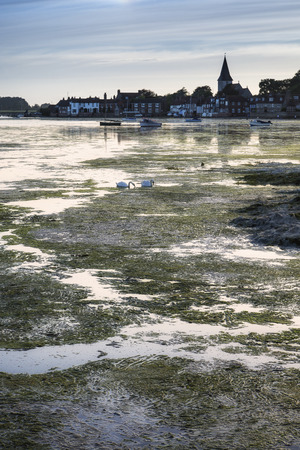 Landscape peaceful harbour at sunset with yachts in low tideの写真素材