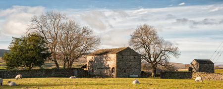 Panorama landscape traditional stone barn in Autumnal countryside の写真素材