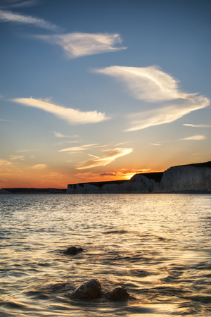Beautiful landscape image of sunset over Birling Gap in Englandの写真素材