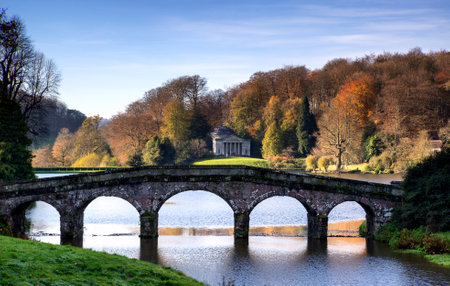 Bridge over main lake in Stourhead Gardens during Autumn.のeditorial素材
