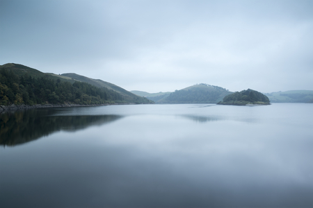 Moody landscape image of lake pre-dawn in Autumn