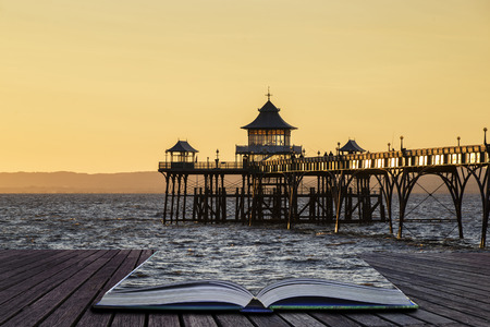 Stunning long exposure sunset over ocean with pier silhouette conceptual book imageの写真素材