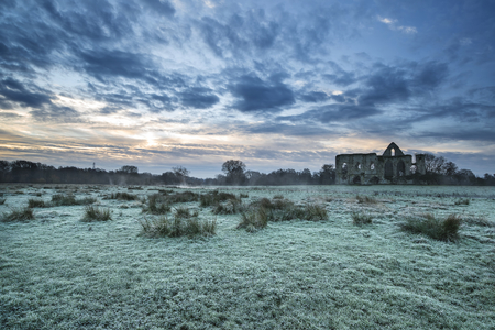 Beautiful dawn landscape of Priory ruins in countryside locationの写真素材