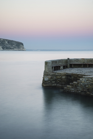 Long exposure landscape of stone jetty in calm seasの写真素材