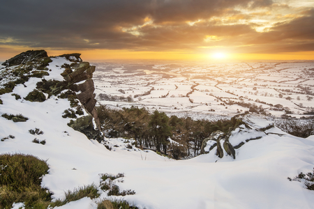 Stunning Winter sunset landscape from mountains looking over countrysideの写真素材