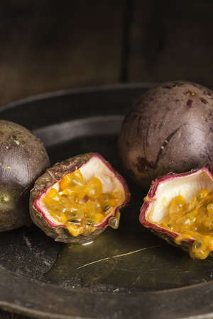 Passion fruit in moody natural light setting with vintage styleの写真素材