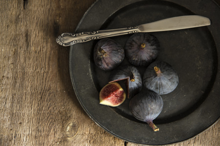 Fresh figs in moody natural lighting set with vintage styleの写真素材