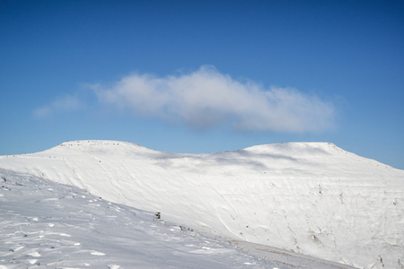 Stunning blue sky mountain landscape in Winter with snow covered slopesの写真素材