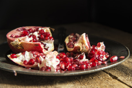 Moody natrual lighting images of fresh juicy pomegranate with vintage styleの写真素材