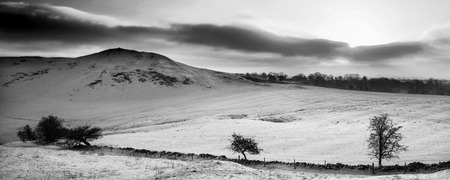 Stunning Winter panorama landscape snow covered mountain in black and whiteの写真素材
