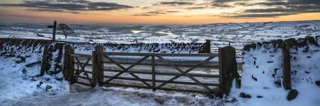 Stunning Winter panorama landscape snow covered countryside with beautiful sky and clouds