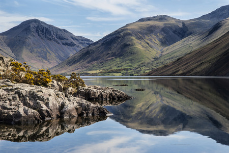 Stunning landscape of Wast Water and Lake District Peaks on Summer day reflected in perfect lakeの写真素材
