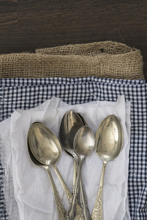 Vintage cutlery on cloths on wooden backgroundの写真素材
