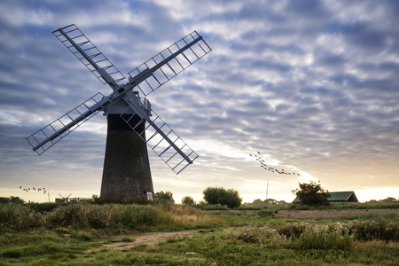 Old windpump windmill in English countryside landscape early morningの写真素材