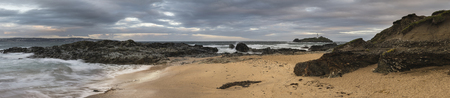 Stunning sunrise landscape image of Godrevy in Corwnall Englandの写真素材
