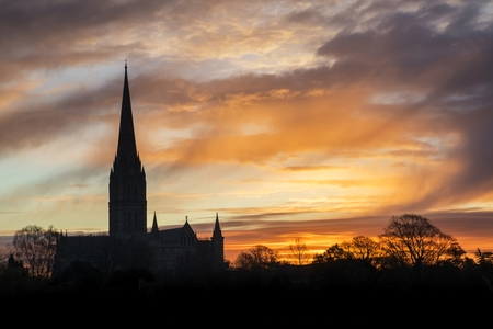 Winter sunrise landscape Salisbury cathedral city in Englandの写真素材