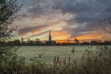 Winter sunrise landscape Salisbury cathedral city in Englandの写真素材
