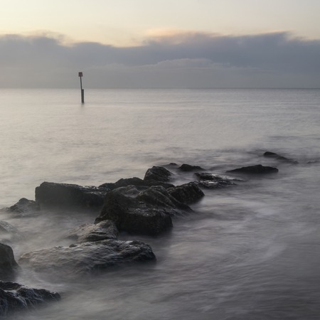 Beautiful sunrise landscape over rocks in seaの写真素材