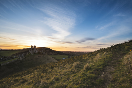 Landscape image of enchanting fairytale castle ruins during beautiful sunsetの写真素材
