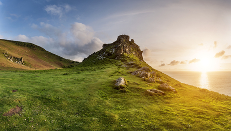 Beautiful sunset landscape image of Valley of The Rocks in Devon Englandの写真素材