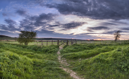 Stunning English countryside panorama landscape over fields at sunsetの写真素材