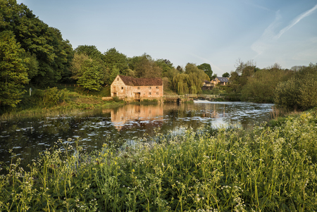 Early morning landscape across River to old Millの写真素材