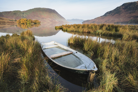 Stunning Autumn Fall landscape image of Crummock Water at sunrise in Lake District Englandの写真素材