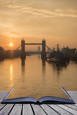 Stunning Autumn Fall sunrise over Tower Bridge and River Thames in London coming out of pages of bookの写真素材