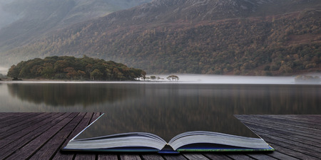 Stunning Autumn Fall landscape image of Crummock Water at sunrise in Lake District England coming...