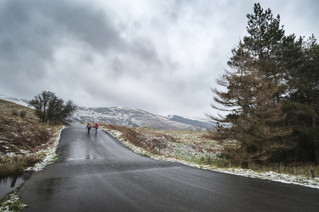 Stunning Winter landscape image around Mam Tor countryside in Peak District England with hikers walking uphillの写真素材