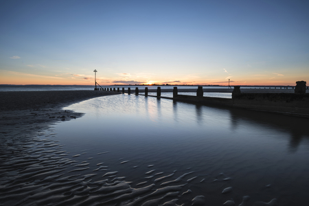 Beautiful Spring sunset long exposure beach landscapeの写真素材