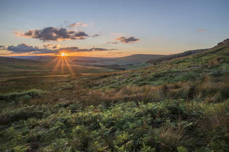 Beautiful landscape image of Stanage Edge during Summer sunset in Peak District Eglandの写真素材