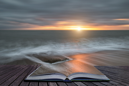Creative book image of Beautiful sunset landscape image of Burton Bradstock golden cliffs in Dorest Englandの写真素材
