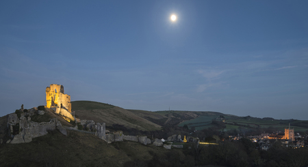 Medieval castle landscape during Autumn dusk light with moonの写真素材