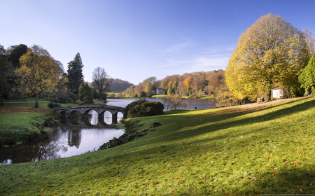Bridge over lake in beautiful landscape Gardens during Autumnの写真素材
