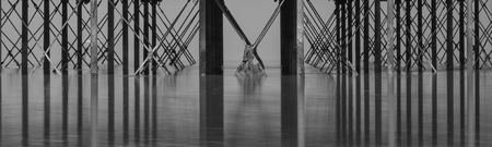 Minimalist fine art image of underside pier showing pattern of beams used in constructionの写真素材