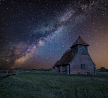 Stunning vibrant Milky Way composite image over landscape of Ancient Medieval churchの写真素材