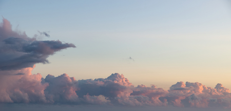 Stunning cumulonimbus storm and rain cloud formations in Summer sunset sky with dramatic moody color...