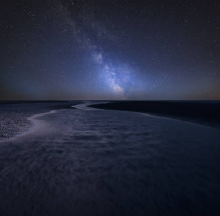 Stunning vibrant Milky Way composite image over landscape of beautiful beachの写真素材