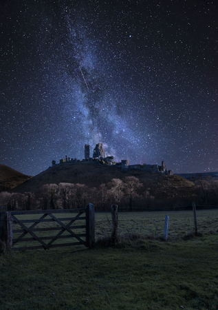 Stunning vibrant Milky Way composite image over landscape of Medieval castle ruinsの写真素材