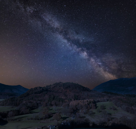 Stunning vibrant Milky Way composite image over Catbells landscape near Derwentwater in the Lake District with vibrant Fall colors all around the contryside vistaの写真素材