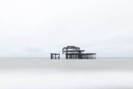 Landscape image of derelict Victorian West Pier at Brighton in West Sussex with moody evening skyの写真素材