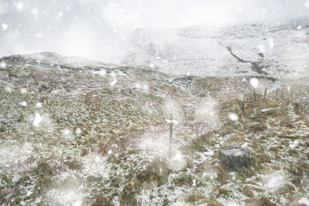 Stunning Winter landscape image around Mam Tor countryside in Peak District England in heavy snow stormの写真素材