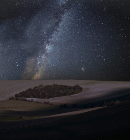 Stunning vibrant Milky Way composite image over landscape of countryside of rolling hills and...