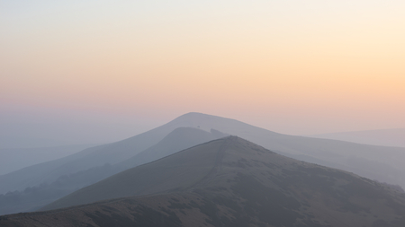 Beautiful Winter sunrise landscape image of The Great Ridge in the Peak District in England with...