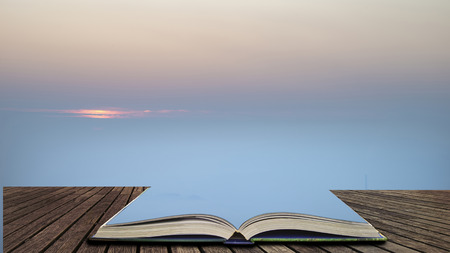 Beautiful Winter sunrise landscape image of The Hope Valley in the Peak District in pages of open book, story telling conceptの写真素材