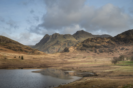Stunning sunrise landscape image of Blea Tarn in UK Lake District with Langdales Range in backgroundの写真素材