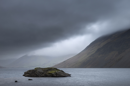 Beautiful long exposure landscape image of Wast Water in UK Lake District during moody Spring eveningの写真素材