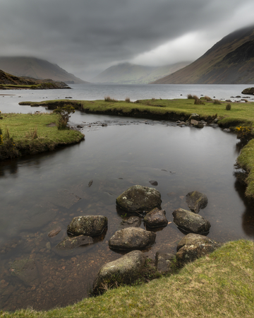 Beautiful long exposure landscape image of Wast Water in UK Lake District during moody Spring eveningの写真素材